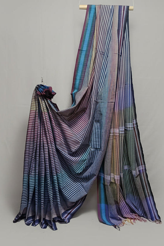 Colorful striped saree draped over a white background