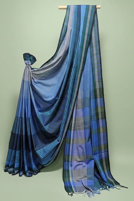 Blue and green plaid Saree draped over a wooden rod against a white background