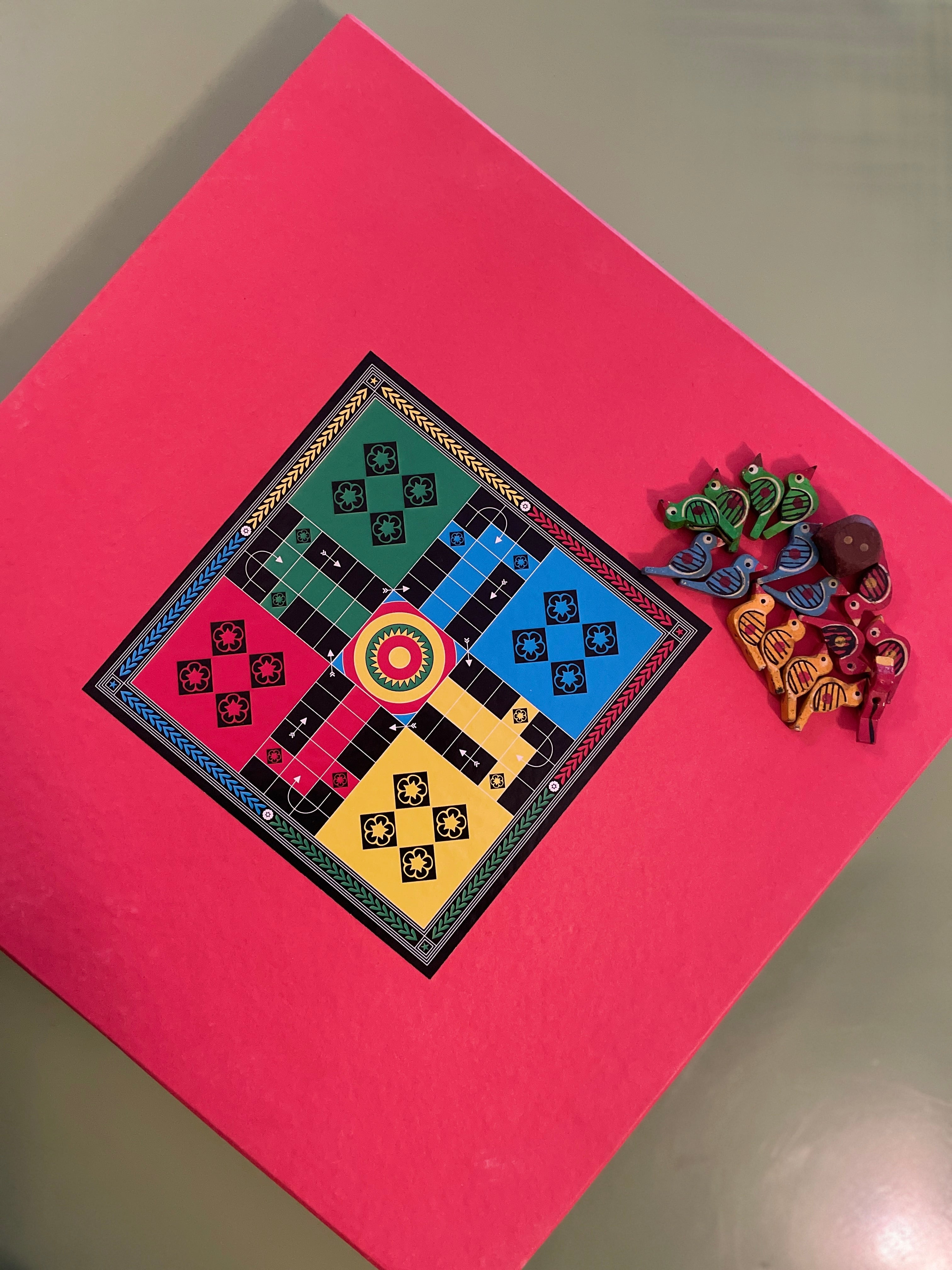 Handcrafted wooden Ludo board game with colorful bird-shaped tokens