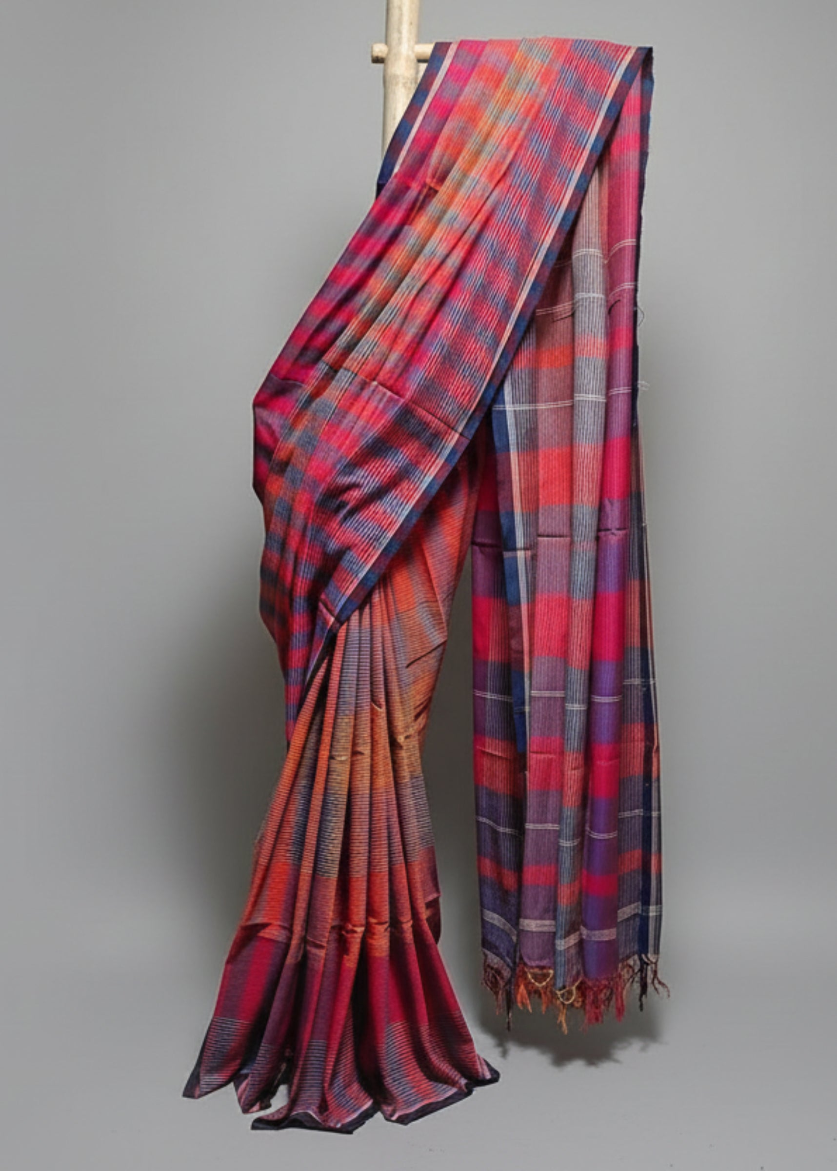 Colorful plaid fabric draped over a white background