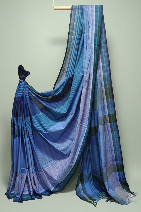 Blue and green plaid saree draped over a white background