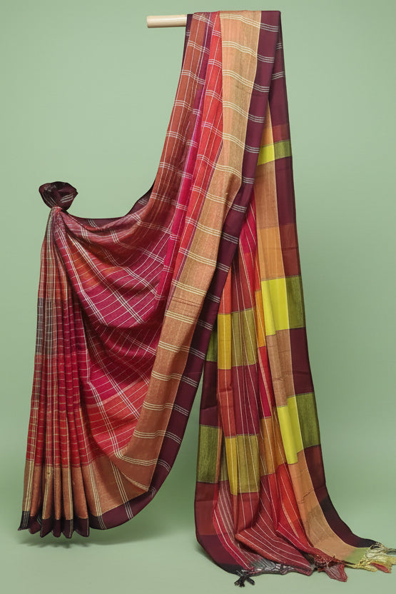 Colorful plaid saree draped over a white background