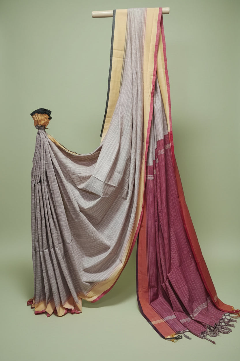 sarees draped over a mannequin against a plain background