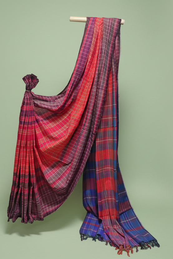 Red and blue plaid saree draped over a white background