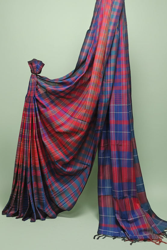 Red and blue plaid saree draped over a white background