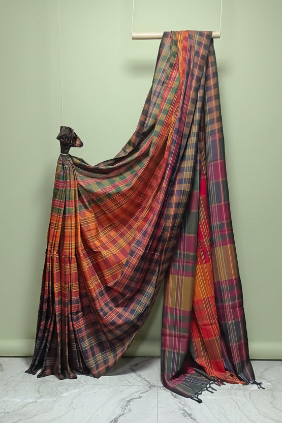 Plaid saree draped over a mannequin against a white background