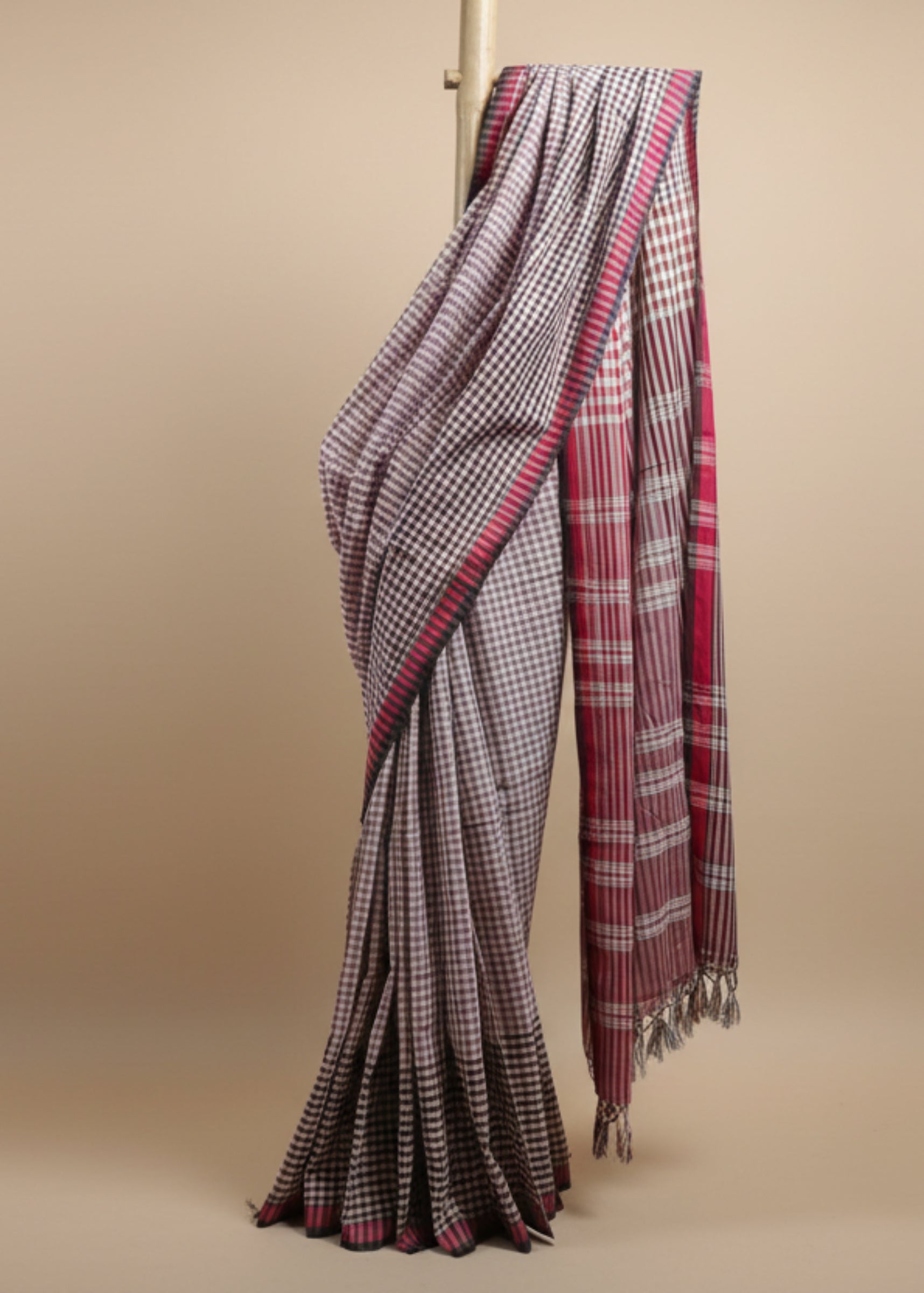 Plaid patterned fabric draped over a door frame against a plain background