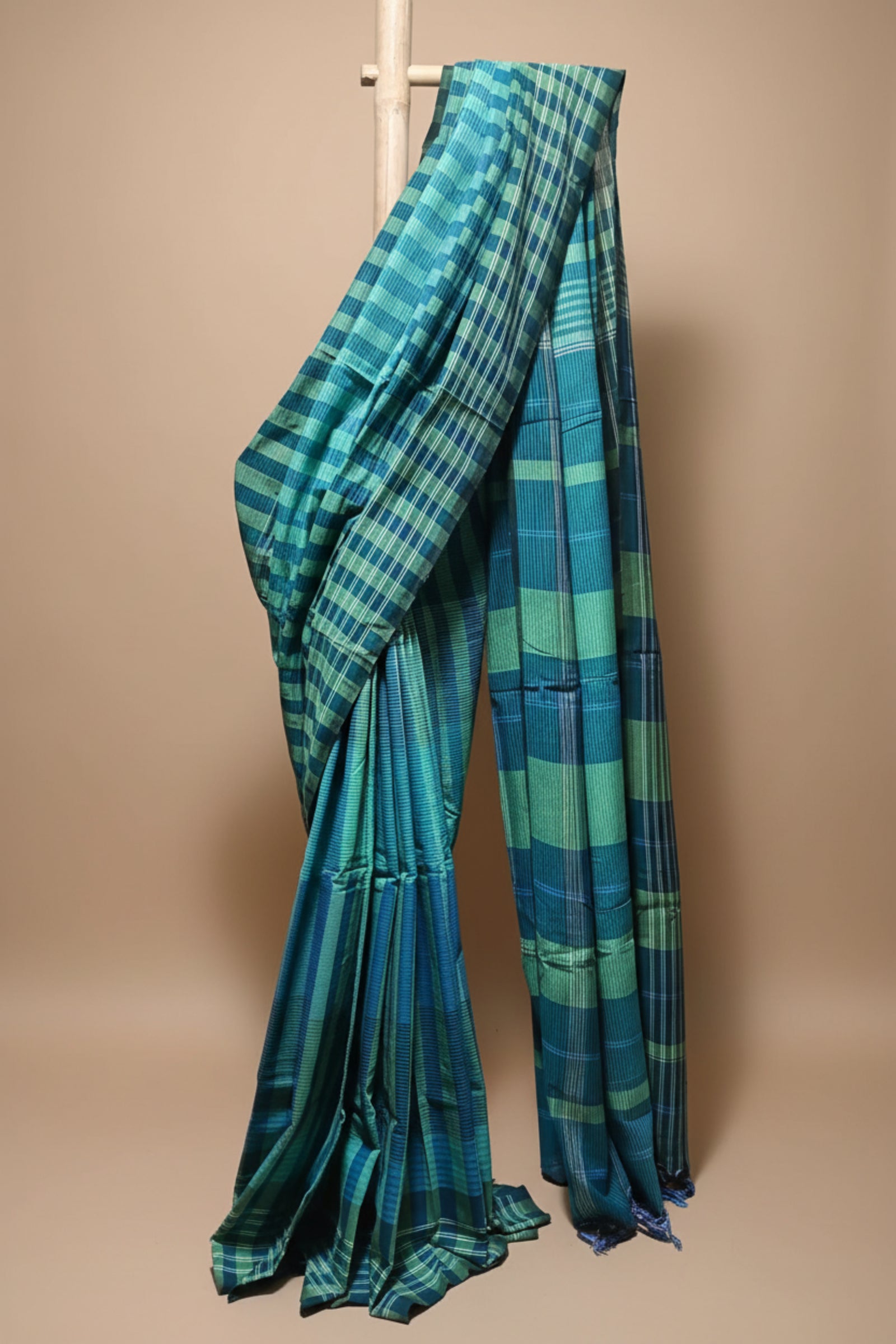 Blue and green plaid fabric draped over a white background