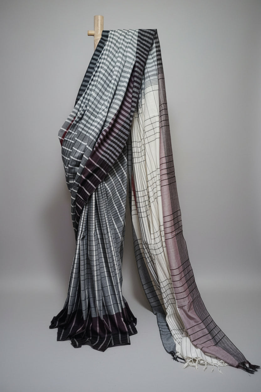 Plaid Saree draped over a wooden hanger against a neutral background